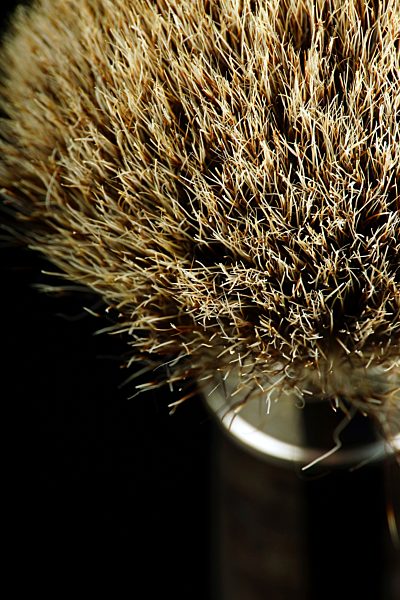 Shaving brush on black background, close up