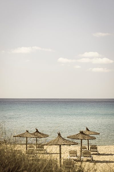 Spain, Formentera, Es Arenals, sunshades and beach chairs
