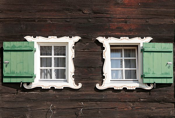 Switzerland, Grindelwald, facade of traditional frame house with two windows and shutters