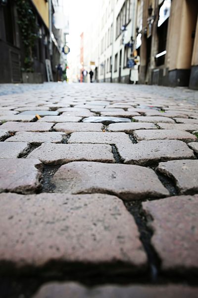 Germany, North Rine-Westphalia, Cologne, cobblestone pavement at historic city