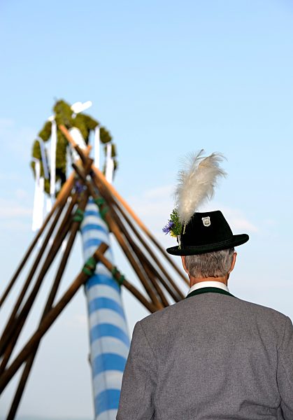 Germany, Bavaria, Man in front of maypole