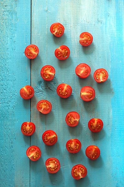 Cross section of tomatoes on wooden table, close up