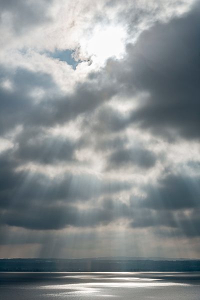 Germany, View of breakthrough of sun rays at lake