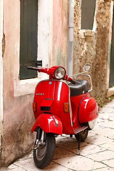 Greece, Ionic Islands, Corfu, Greece, Ionic Islands, Corfu, red old Vespa scooter parking in front of house