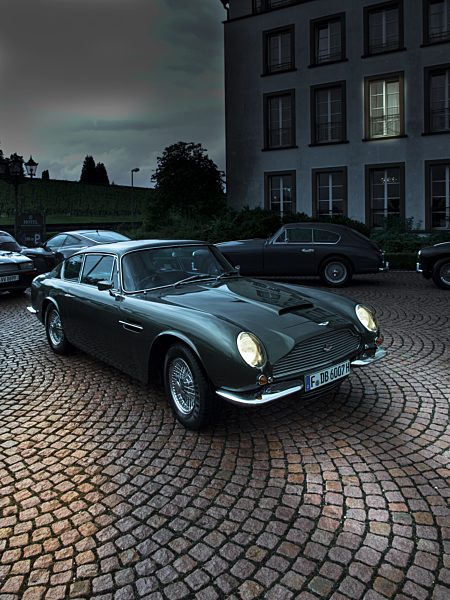 Parking Aston Martin DB 6 with lighted headlights