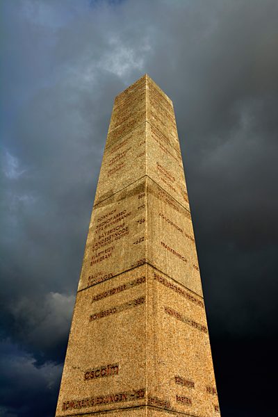 Germany, Bavaria, Stone obelisk with dark clouds