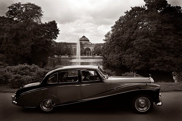 Germany, Hesse, Wiesbaden, Rolls Royce Silver Cloud Hooper Empress driving in front of spa park