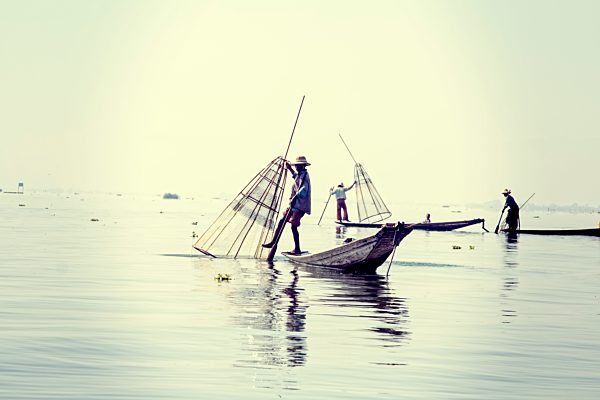 Myanmar, Lake Inle, Fishermen on boats with fish traps