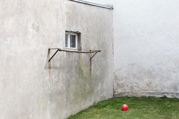 Germany, glum backyard with red ball