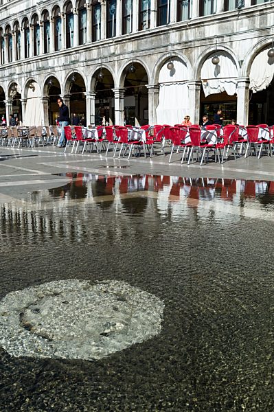 Italy, Venice, St Mark's Square, Water flowing through manhole cover