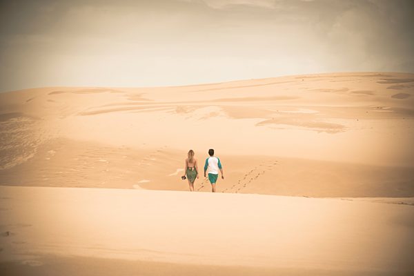 Australia, New South Wales, Woromi Conservation Lands, couple walking in desert dunes