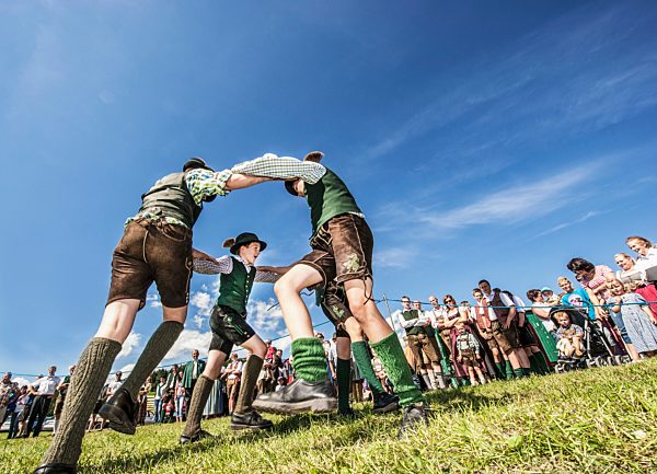 Austria, Irdning, Boys in traditional clothing dancing the Schuhplattler at May festival