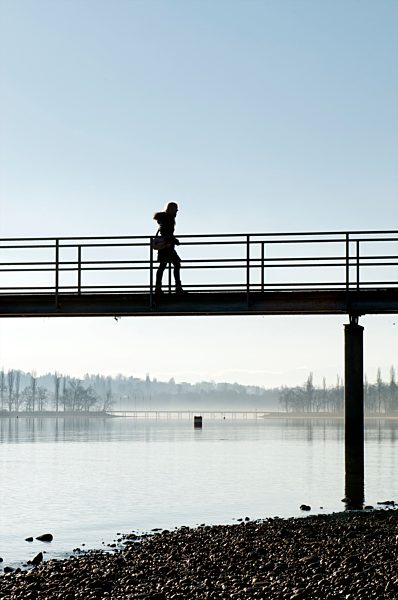 Germany, Baden-Wuerttemberg, Constance District, Lake Constance, Mainau, woman walking on jetty