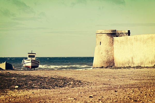 Spain, Andalusia, round tower of a fortress at the sea