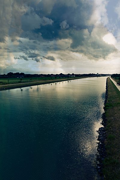 Germany, North Rhine-Westphalia, Riesenbeck, Dortmund-Ems-Kanal and clouds in the evening