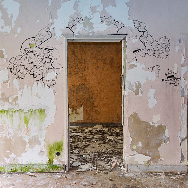 Portugal, Azores, San Miguel, doorframe and drawings on wall in empty hotel ruin