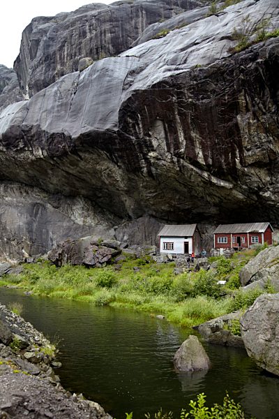 Norway, View of old fisher houses under mountain at Helleren