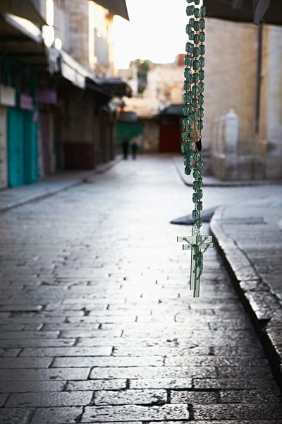 Israel, Jerusalem, View of street with crucifix hanging