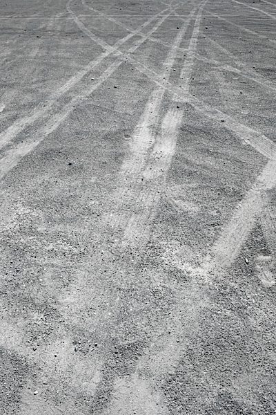 Spain, Fuerteventura, Puerto de La Cruz, car tracks on grey ground