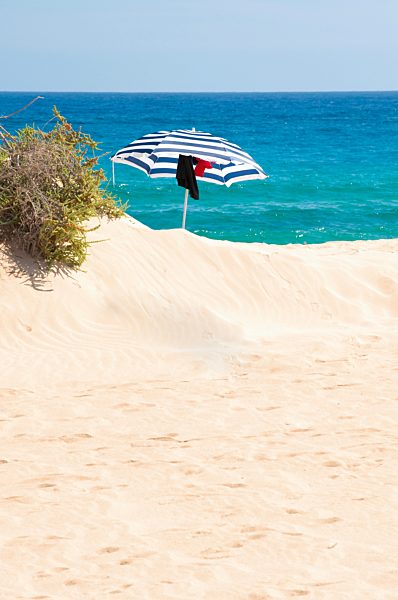 Spain, Fuerteventura, Corralejo, Parque Natural de Corralejo, beach umbrella on the beach