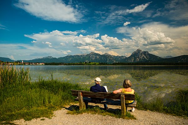 Germany, Bavaria, Allgaeu, East Allgaeu, Lake Hopfensee, near Fuessen, Old couple on wooden bench