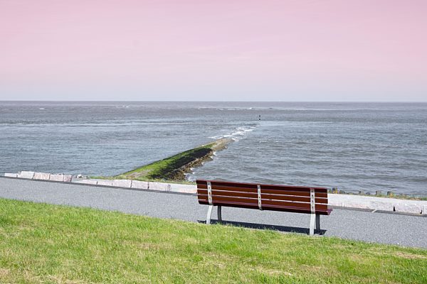 Germany, Lower Saxony, Baltrum, view to the sea and bench in the foreground