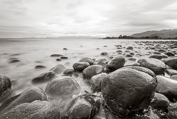 New Zealand, Golden Bay, stones at waterside of beach, longtime exposure