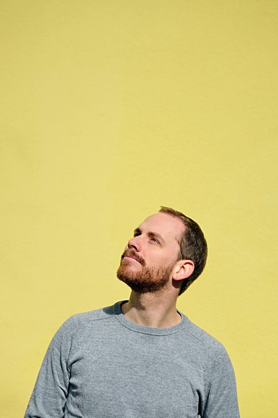 Portrait of young man in front of yellow background