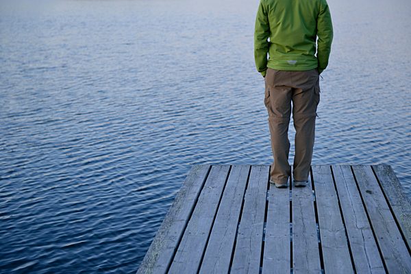 Sweden, Storuman, Man standing on jetty by the lakeside