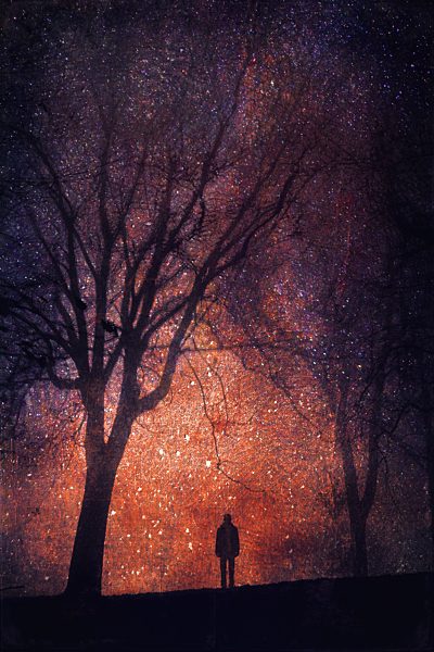 Silhouette of person in front of starry sky, composite