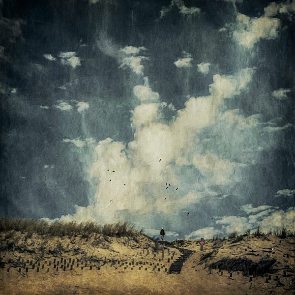 France, Aquitaine, Contis-Plage, man walking on a beach dune