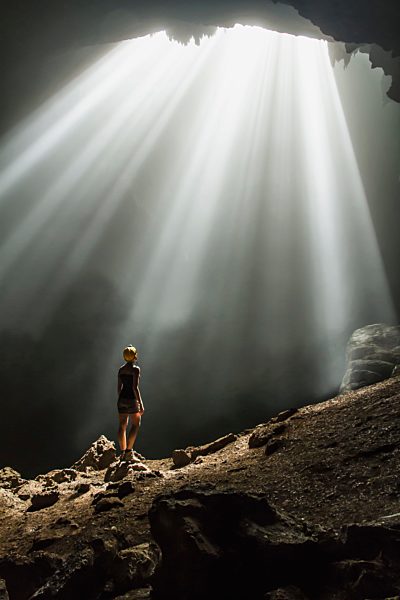 Indonesia, Young woman looking at sunbeam