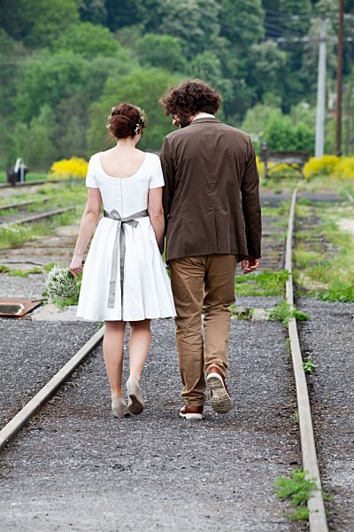 Bridal couple jon the move, back view