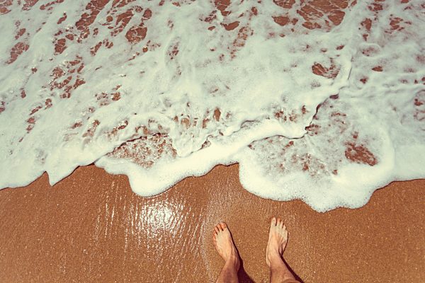 New Zealand, New Chums Beach, feet in the ocean