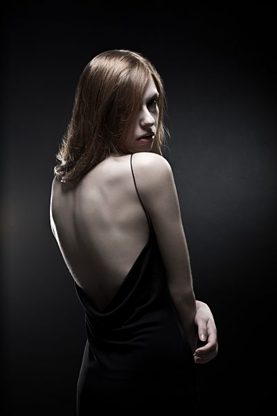 Young woman in black dress, close up