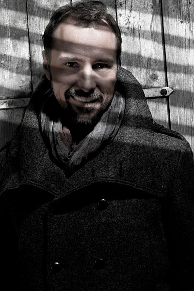 Portrait of mature man leaning on door