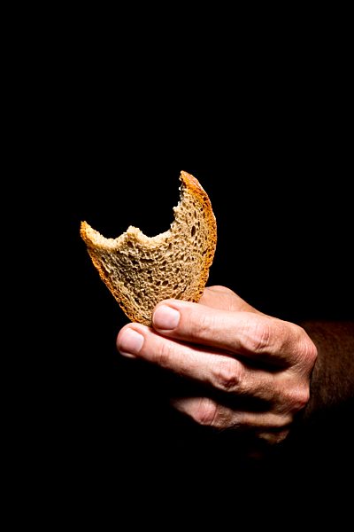 Mature man holding bread, close up