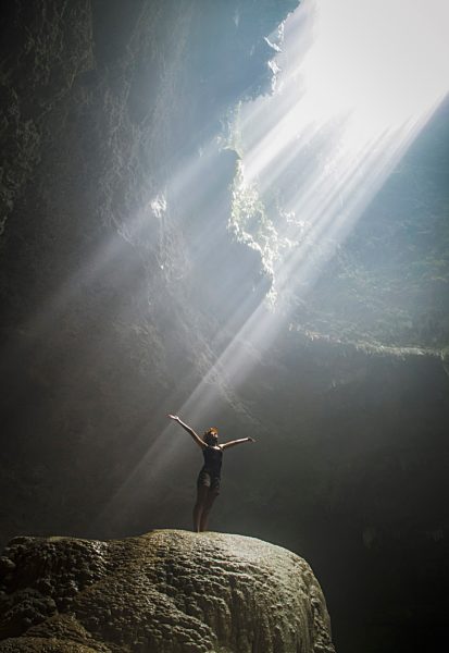 Indonesia, Young woman looking at sunbeam