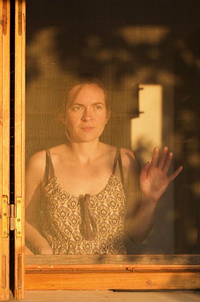 Greece, Ionian Islands, Ithaca, Mid adult woman standing at window