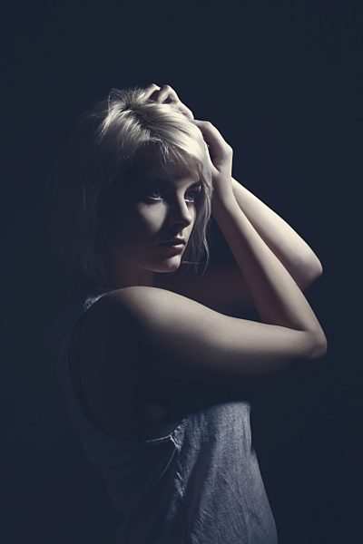 Young woman looking away, close up