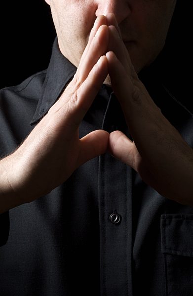 Mid adult man folds his hands, close up