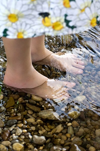 Germany, Bavaria, Landshut, Girl standing in water, close up