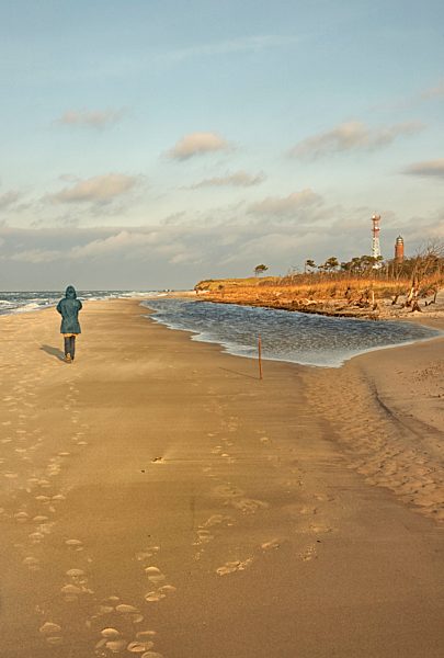 Germany, Mid adult woman walking on beach