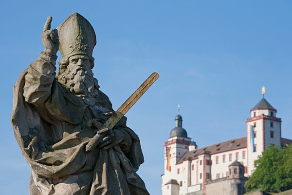 Germany, Bavaria, Franconia,Stone-Carved Statue of a Saint and the Marienberg Fortress