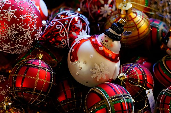Collection of different christmas baubles, one formed as a snowman