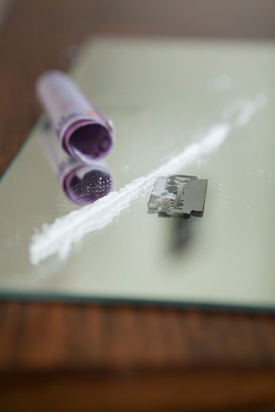 Drugs divided with razor blade,close up