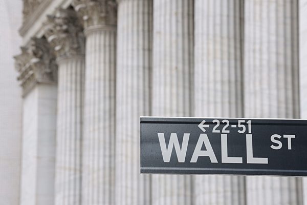 USA, New York State, Manhattan, Wall street sign against Stock Exchange pillars