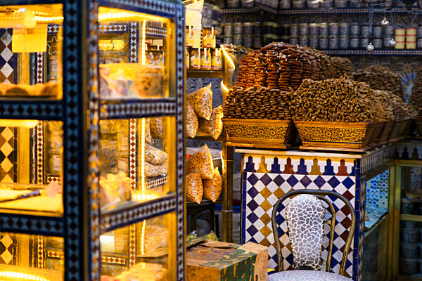 Traditional Moroccan sweets displayed in a colorful Fez market bakery