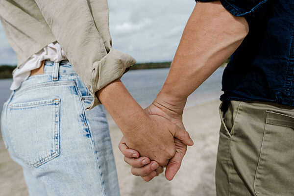 Couple holding hands outdoors symbolizing trust and connection