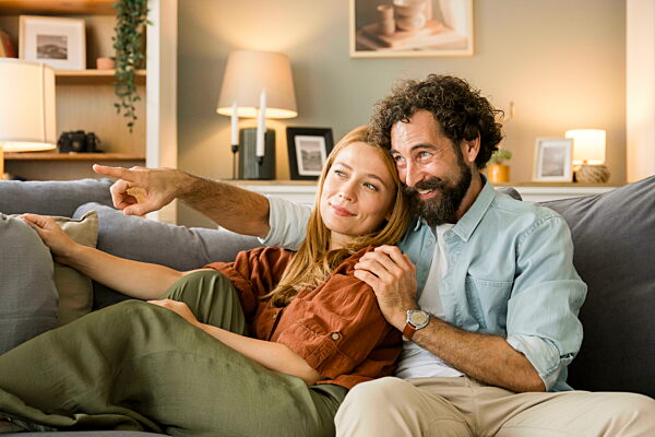 Couple sitting on couch enjoying time together at home
